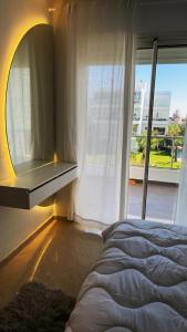 a bedroom with a bed and a window at Seaside studio with pool in Dar Bouazza +44 photos