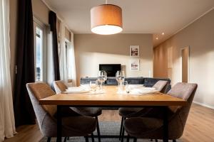a dining room with a table with wine glasses at Design-FeWo Sonnendeck in Winterberg