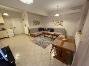 a living room with a couch and a table at Ourania's Apartment Kastoria in Mavrokhórion