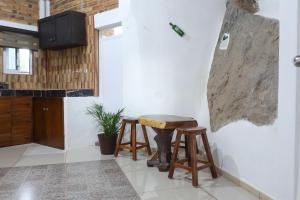 a kitchen with a table and two stools at Las Cabañas del Tio Lalo in Rincon de Guayabitos