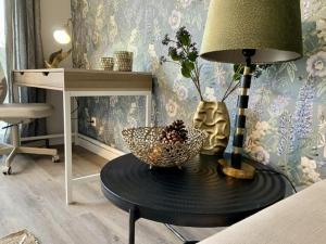 a room with a table with a lamp and a desk at Blue Meadow in Rheda-Wiedenbrück