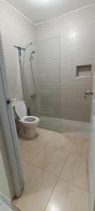 a bathroom with a toilet and a glass shower at HEA Stays II in San Felipe de Puerto Plata