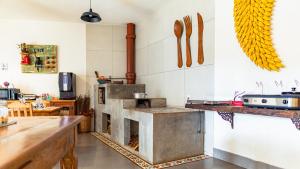 a kitchen with an oven in the middle of a room at Pouso da Rita - Tiradentes in Tiradentes