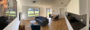 a living room with a couch and a table at Ferienwohnung Karrensicht in Dornbirn