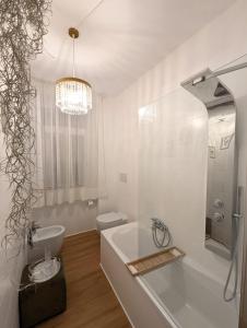 a bathroom with a tub and a toilet and a sink at La Suite dei Cristalli - Gorizia Central Apartment in Gorizia