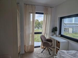 a bedroom with a chair and a desk and a window at Villa Seaview in Nadole