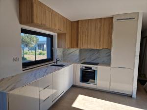 a kitchen with white cabinets and a window at Villa Seaview in Nadole