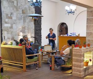 a group of people sitting at tables in a restaurant at Tambo Aymara in Uyuni