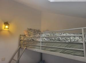 a bunk bed in a small room with a lamp at Ca Na Martina in Carreña de Cabrales