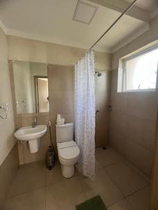 a bathroom with a toilet and a sink at Pousada Recanto da Estação in São João da Boa Vista