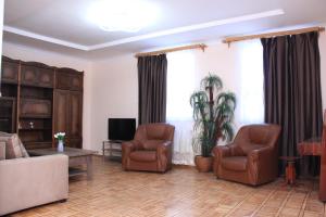 a living room with two chairs and a couch at Old Friends Cozy House in Gyumri