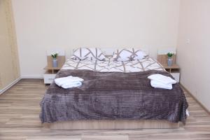 a bedroom with a bed with two towels on it at Old Friends Cozy House in Gyumri +7 photos