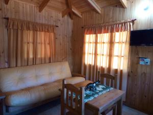 a living room with a couch and a table at Cabañas DON CATALINO in Candelaria