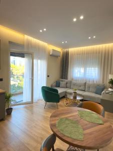 a living room with a couch and a table at Ideal Apartment Shkoder in Shkodër