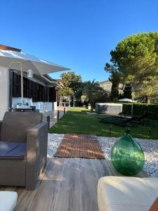 a patio with a couch and a vase on a table at Villa Antia in San Giovanni a Piro