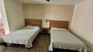 Postel nebo postele na pokoji v ubytování Hotel Amecatl