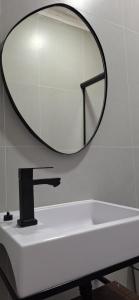 a bathroom with a mirror above a sink at Xodó do Litoral in Caraguatatuba +9 photos