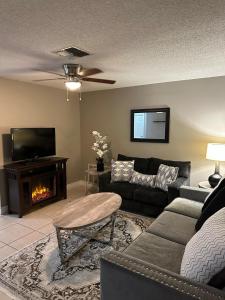 a living room with a couch and a fireplace at Cozy Vacation home in Port Richey