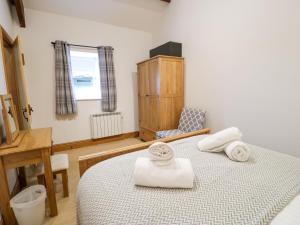 ein Schlafzimmer mit Bett, Schreibtisch und Fenster in der Unterkunft Cornel Glyd in Dyffryn