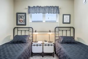 a bedroom with two beds and a window at Wondrous Willow in Fairbanks