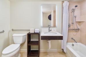 a bathroom with a toilet and a sink and a tub at Hotel Renew in Honolulu +37 photos