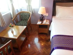 A bed or beds in a room at Grand Laurel Hotel