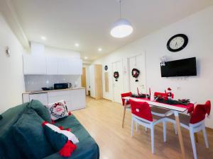 a kitchen and a living room with a couch and a table at Hotel Archi Kokhta Bakuriani Apartment 305 in Bakuriani
