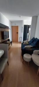 a large living room with a bed and a chair at Apto completo proximo arena pantanal in Cuiabá