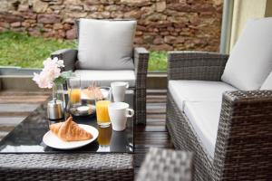 a coffee table with a plate of croissants and drinks at JJ-TS - Zentrale Wohnung - nahe SAP - Parkplatz - Terrasse in Walldorf