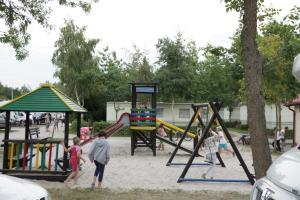 a group of children playing in a playground at Holiday Resort & Camping InterCamp'84 in Łeba