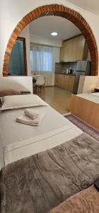 a large room with two beds and a kitchen at Aliaj Guest House in Berat