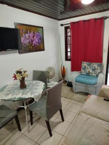un soggiorno con un tavolo e una sedia di Linda casa de veraneio em Gravatá a Gravatá