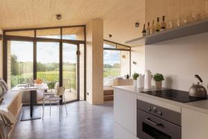 a kitchen and dining room with a view of a living room at Ostsee Baumhaushotel - Auf Höhe der Baumkronen in Wangels