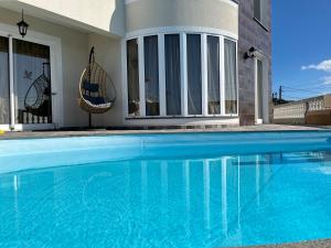 a swimming pool in front of a house at La casita de campo in Ponta do Sol