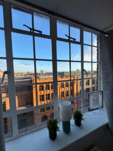a window with a view of a building at Chelsea Studio South Kensington 10 Min to Harrods in London