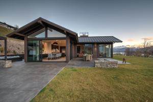 a contemporary house with a glass and wood exterior at Terrace Lodge by Sotheby's Luxury Rental Homes in Queenstown