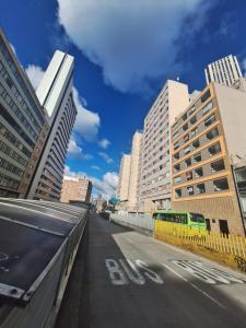 a city street with tall buildings and a bus at Loft centro internacional in Bogotá