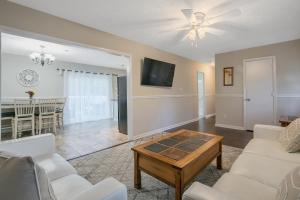 a living room with a couch and a table at Shady Pines Retreat in Hope Mills