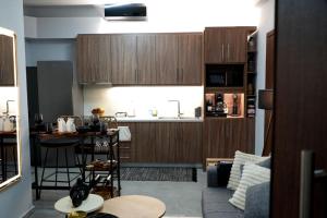 a living room with a couch and a kitchen at Happy Stay in Larisa