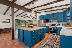 a kitchen with blue cabinets and a large island at Rancho del Plata in Tucson