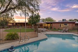 a swimming pool in front of a house at Rancho del Plata in Tucson
