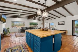 a kitchen with a blue island in a living room at Hacienda del Plata in Tucson