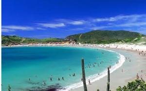 a group of people in the water at a beach at Maravilha de Peró in Cabo Frio