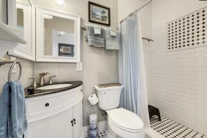 a bathroom with a toilet and a sink and a shower at Pelican Place - Waterfront launch and fire pit in Cedar Key +29 photos