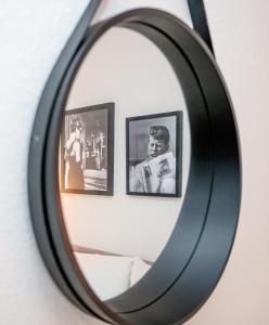 a mirror on a wall with pictures in it at Artful Apartment in Krefeld