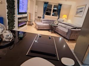 a living room with a couch and a table at Townhouse with 3 bathrooms in Edinburgh