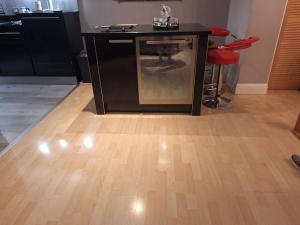 a kitchen with a black counter and a wooden floor at Townhouse with 3 bathrooms in Edinburgh