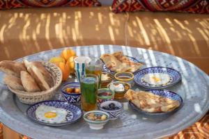 a table topped with blue and white plates of food at Dar YAMINA SUIKA in Chefchaouen