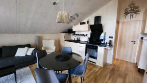 a small living room with a table and a couch at Apartmán Štyri Smreky Demänovská Dolina in Belá