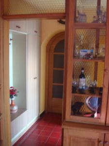 a room with a kitchen with a pantry and a door at Apartments Judit in Tar